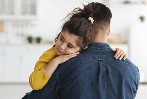 Dad Comforting Upset Little Arab Daughter At Home, Cute Sad Middle Eastern Female Child Hugging Father In Kitchen, Feeling Parent Support And Protection, Free Space