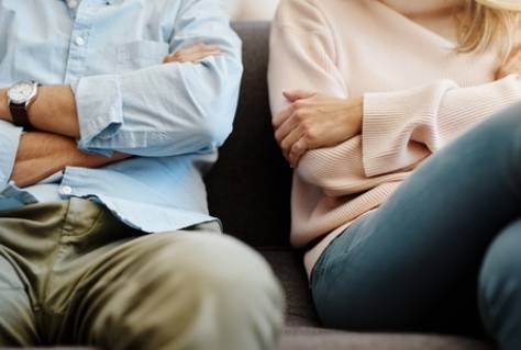 Divorce, sad and couple fight due on a couch due to marriage problem or conflict in a lounge sofa.